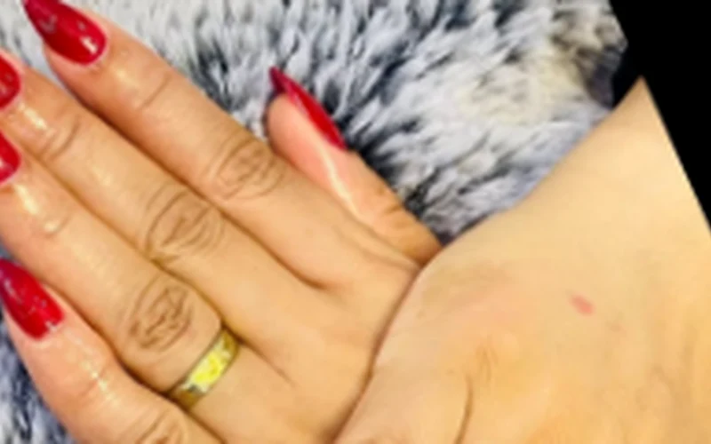 Manicure with polished red nails; photographed at the salon